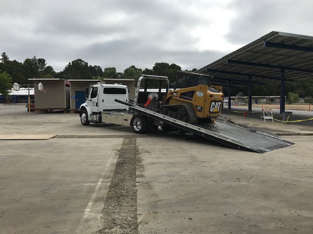 Unloading The Machine From The Truck