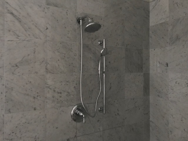A Tub Shower And A Phone Shower In Bathroom