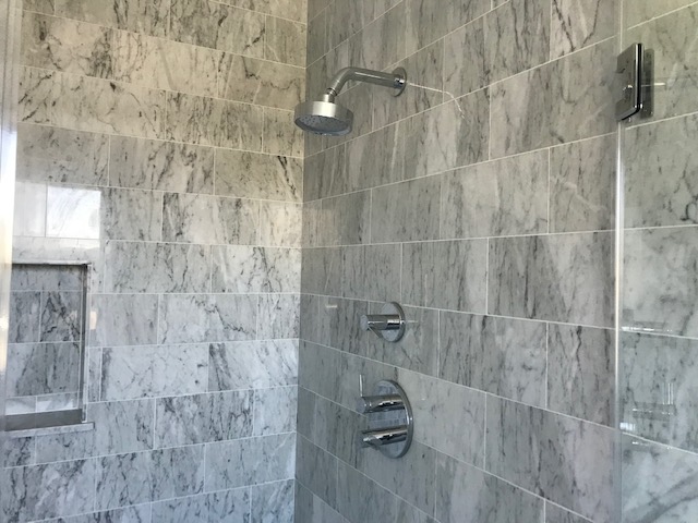 A Steel Tub Shower On The Bath Wall