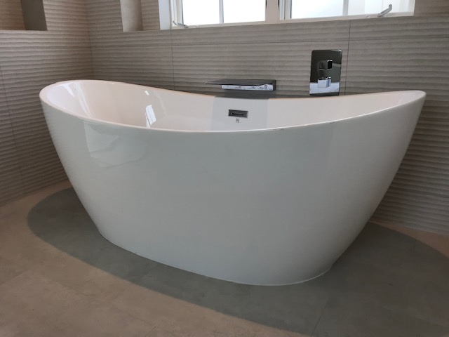 A Bathtub With Modern Tap On The Wall